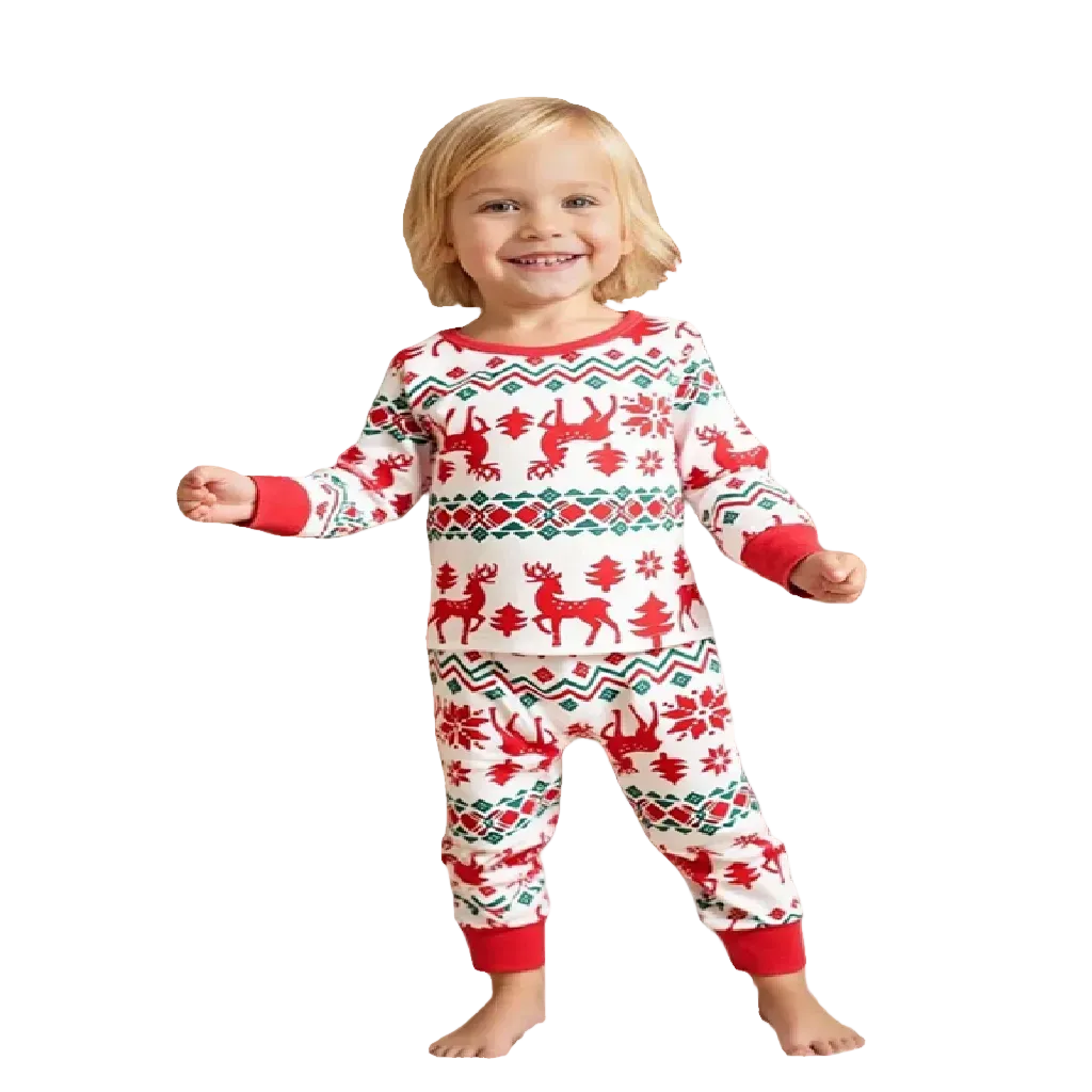 Child wearing a red and white Christmas pajama set with a matching doll in a festive room.