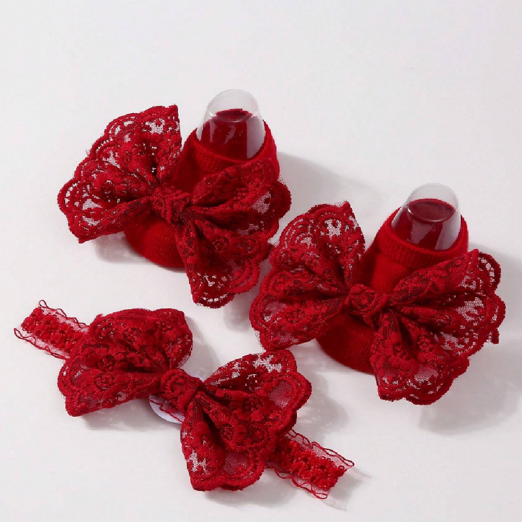 Red lace bow hair clips on a white background