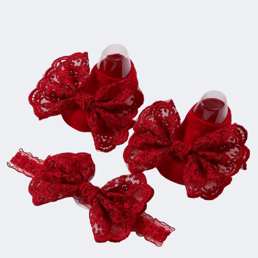 Red lace bow hair clips on a white background