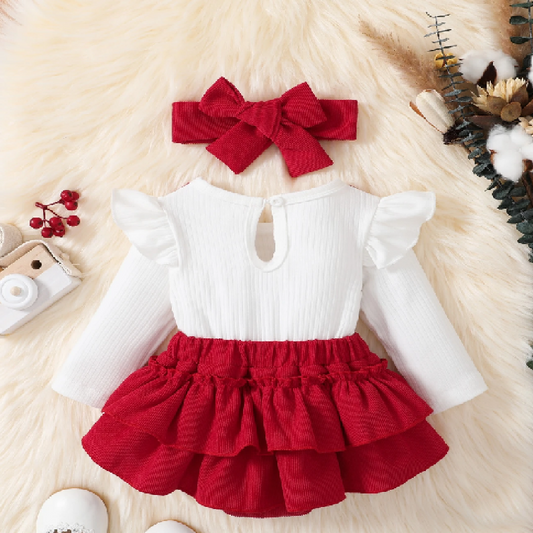 White top with ruffled sleeves and red skirt on a fluffy white surface.