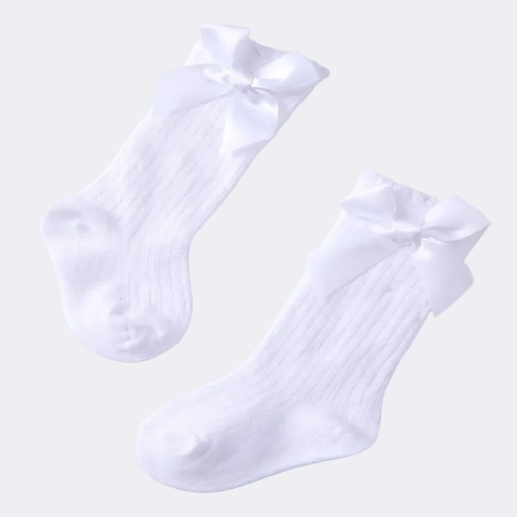 Pair of white socks with bow details on a light background