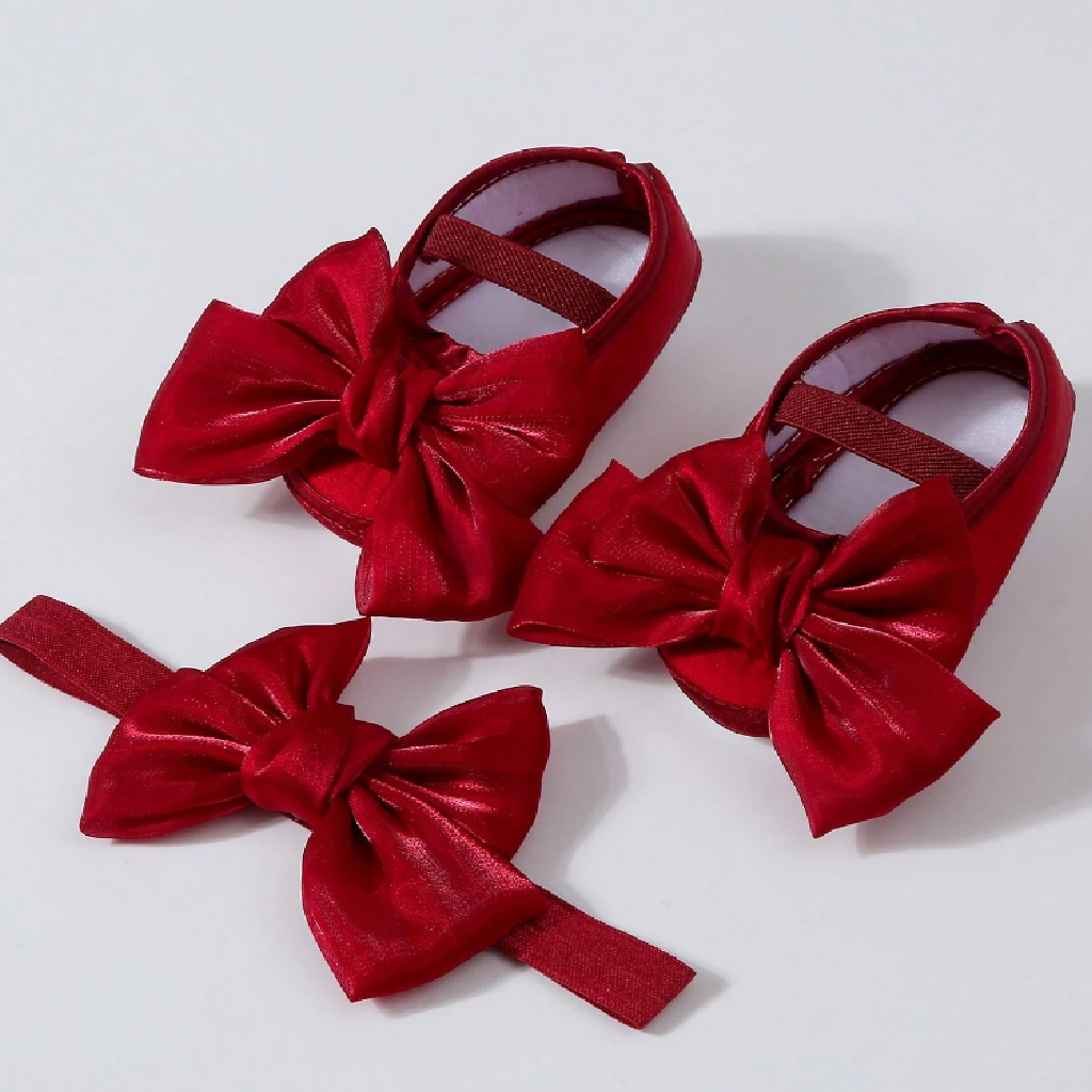 Red shoes with large bows on a white background