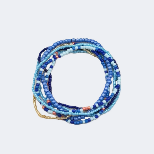 Set of blue and white beaded bracelets on a white background