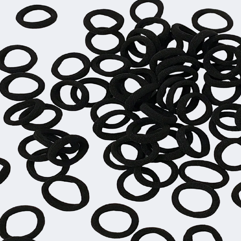 Pile of black hair ties on a white background with measurement label.