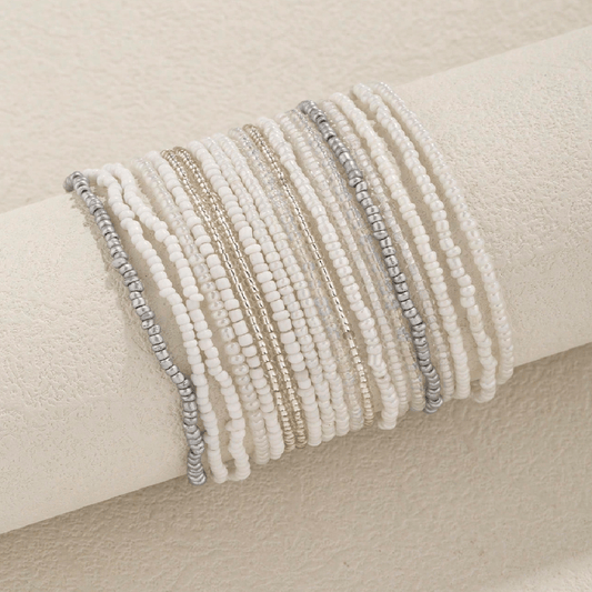 Set of beaded bracelets on a beige surface