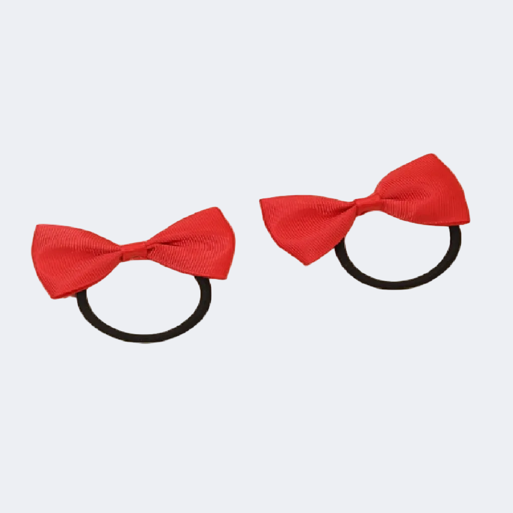 Two red hair bows with black elastic bands on a white background