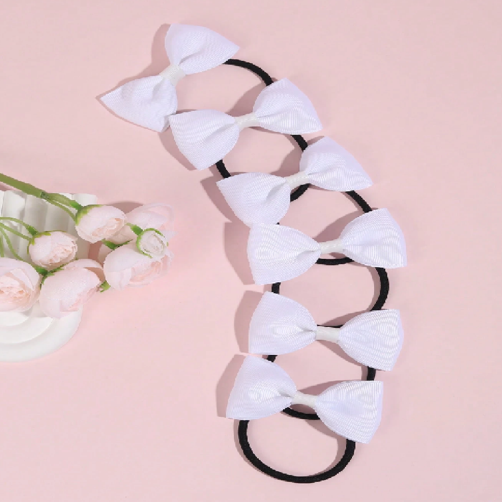 Hair tie with white bows on a pink background