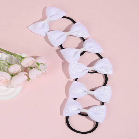 Hair tie with white bows on a pink background