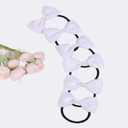 Hair tie with white bows on a pink background