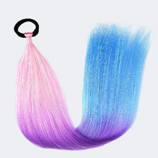 Gradient hair extensions in pink, blue, and purple with a black clip on a white background