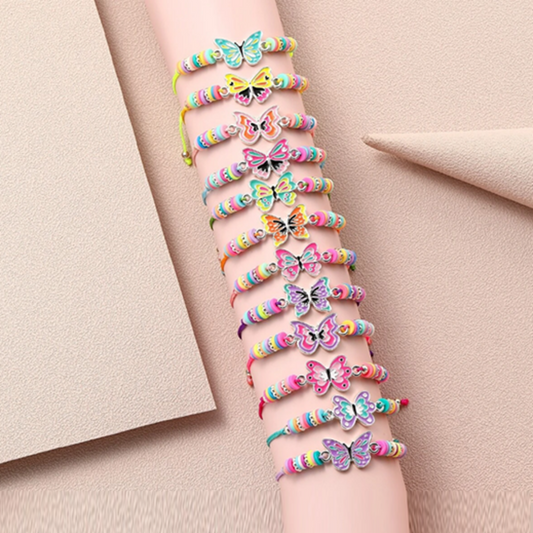 Wrist with colorful butterfly bracelets on a neutral background