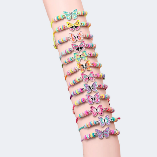 Wrist with colorful butterfly bracelets on a neutral background