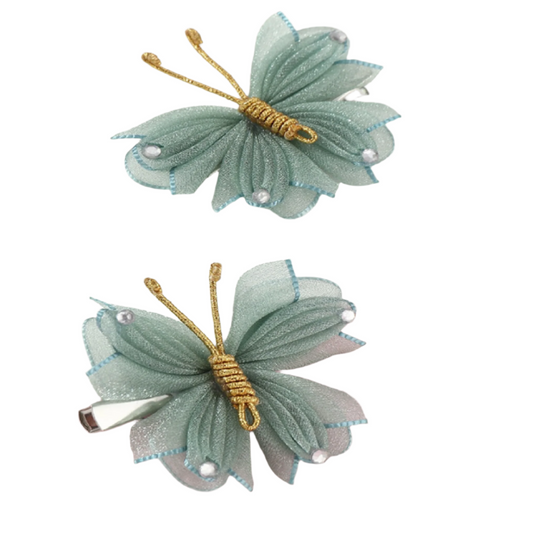 Two green butterfly hair clips with gold accents