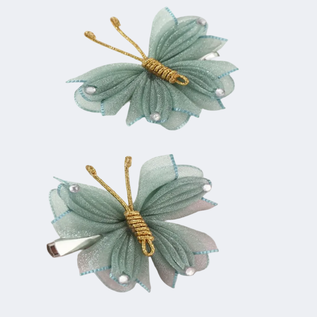 Two green butterfly hair clips with gold accents