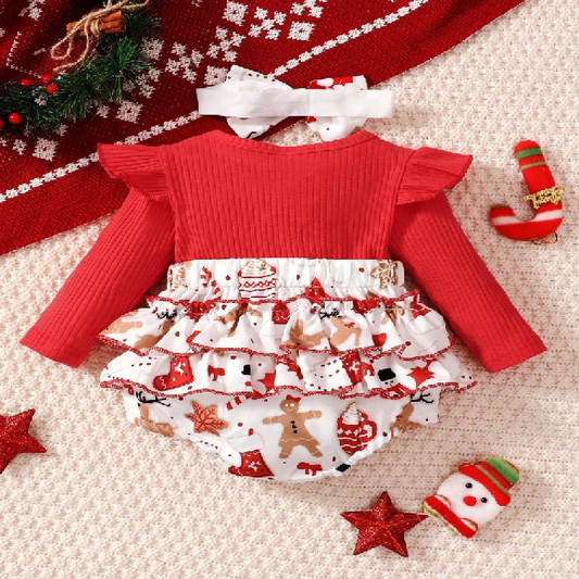 Red sweater and Christmas-themed skirt set on a textured surface with festive decorations.