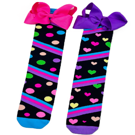Two pairs of socks with colorful patterns and bows on a white background