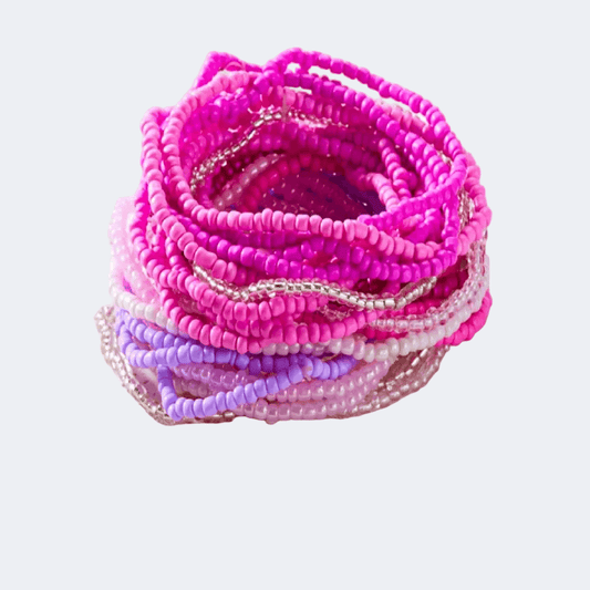 Stack of pink beaded bracelets on a light purple background