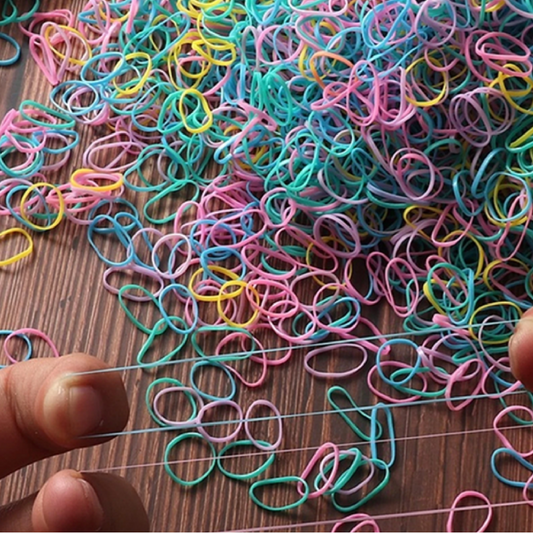 Colorful rubber bands spread out on a surface.