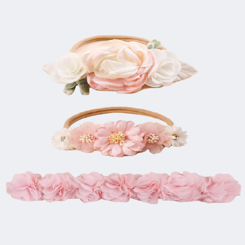 Set of three floral headbands with pink and white flowers on a white background