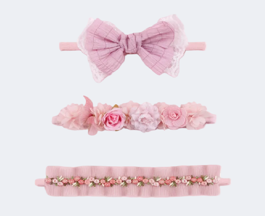 Set of three pink headbands with floral and bow designs