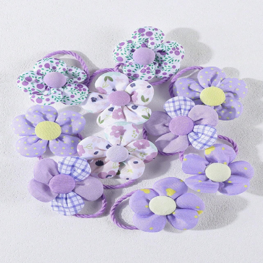 Set of purple floral hair ties on a light gray background