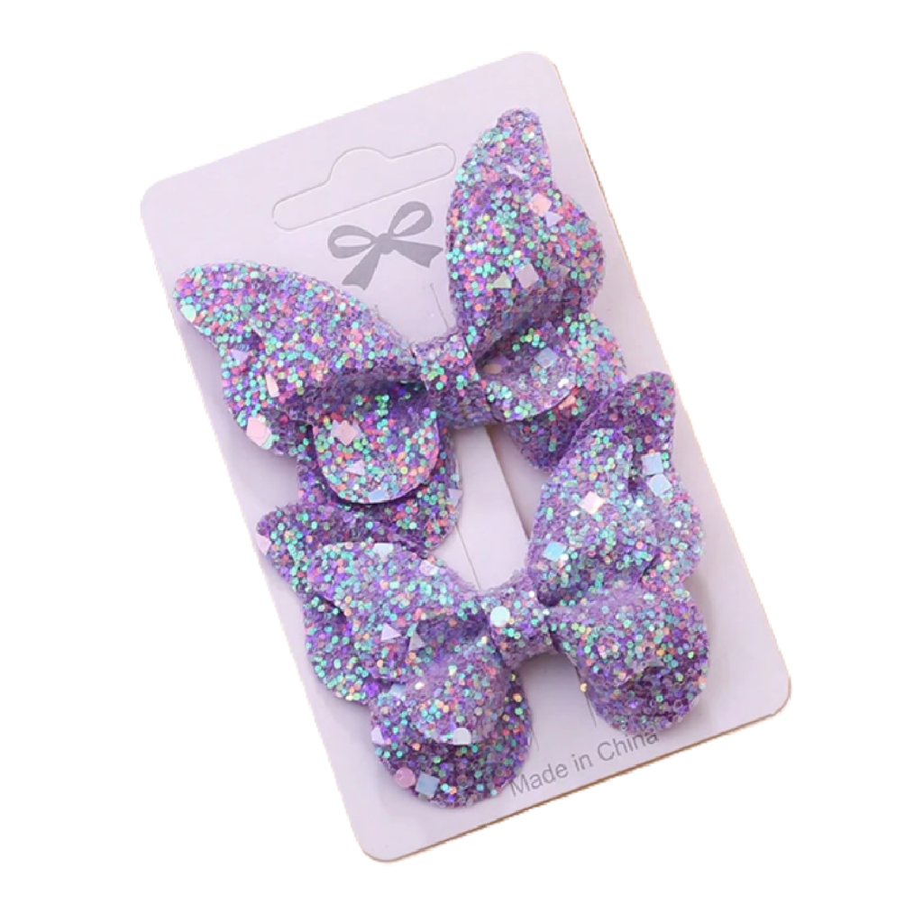 Two purple glittery hair bows