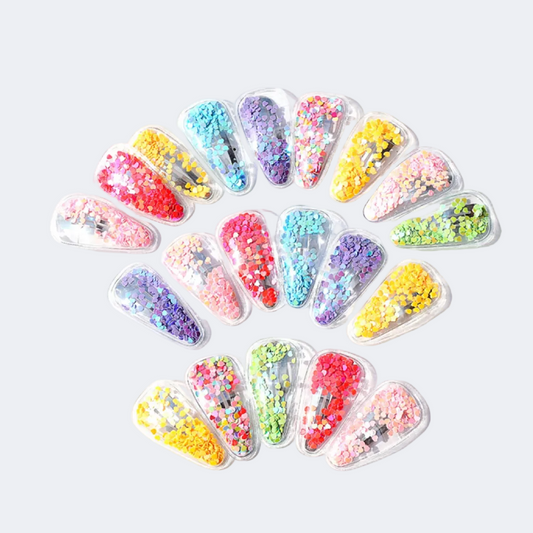 Colorful nail art decorations in clear containers arranged in a circular pattern