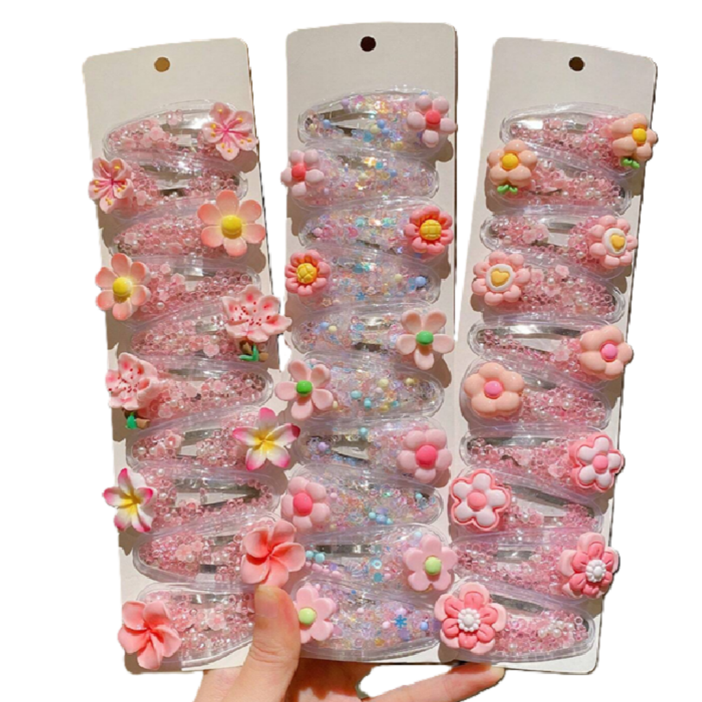 Set of pink floral hair accessories in packaging