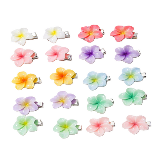 Set of colorful flower-shaped hair clips on a white background