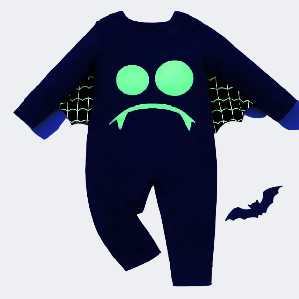 Black baby onesie with green glowing design on a blue background