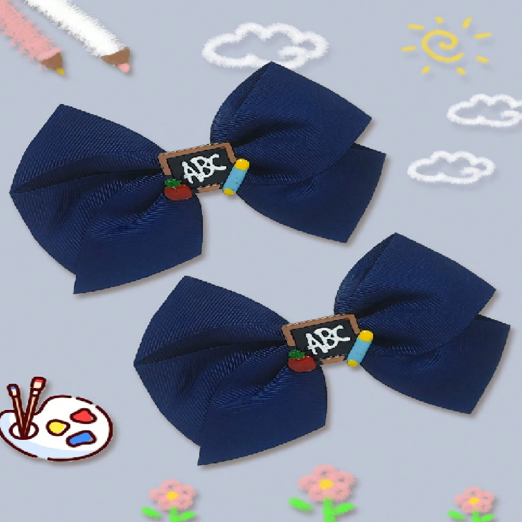 Two navy blue hair bows with 'ABC' clip on a light blue background with doodles.