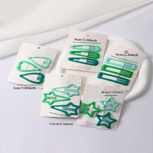 Set of green hair clips on white cards with size labels