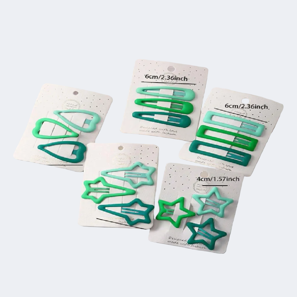 Set of green hair clips on white cards with size labels