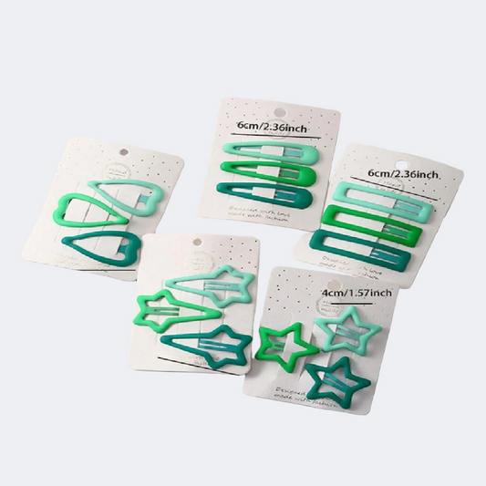 Set of green hair clips on white cards with size labels