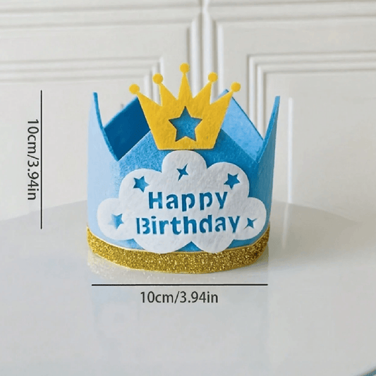 Blue birthday crown with yellow glitter band and crown on a white surface