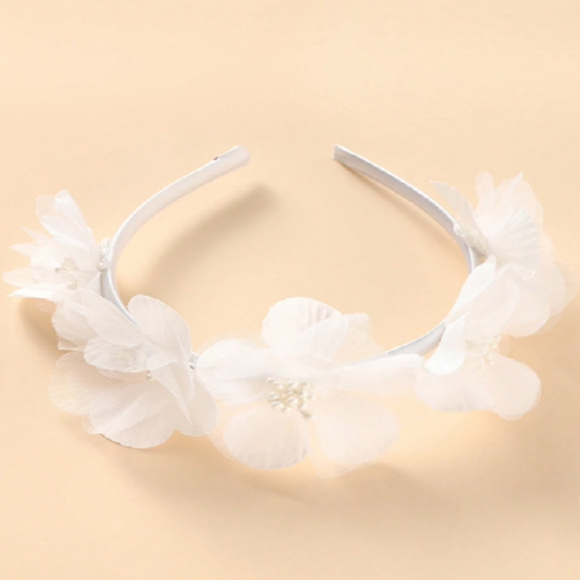 White floral headband on a beige background
