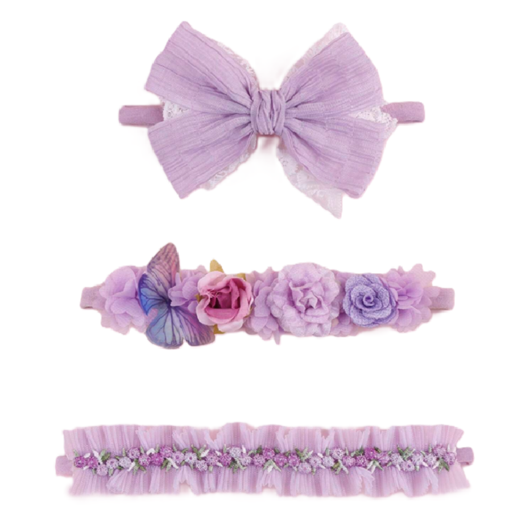 Set of three purple hair accessories including a large bow, floral headband, and decorative headband