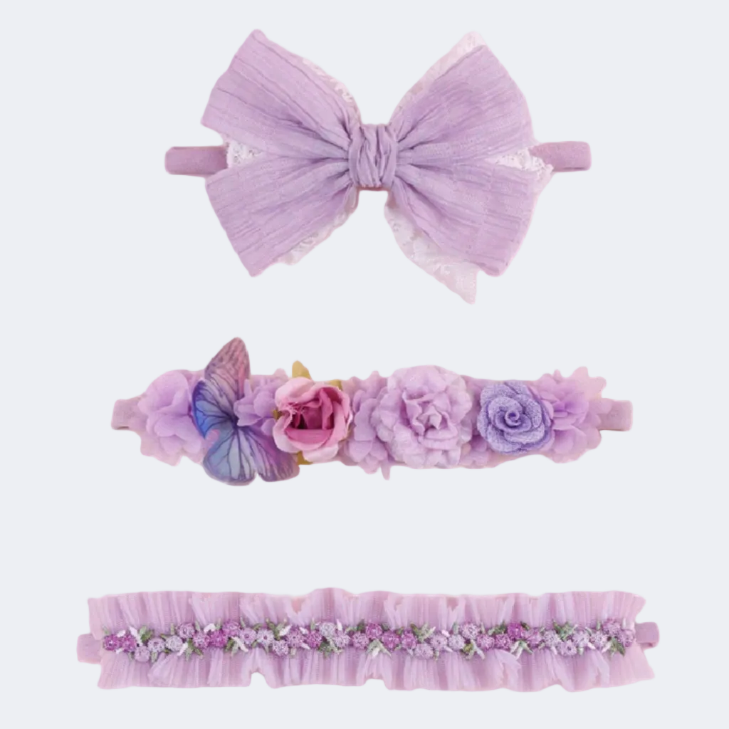 Set of three purple hair accessories including a large bow, floral headband, and decorative headband