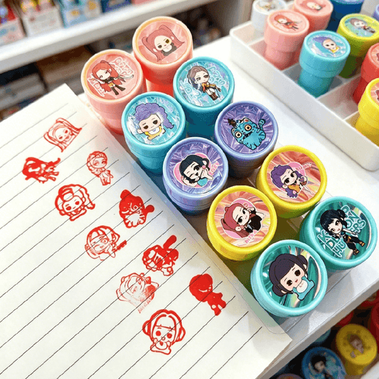 Colorful cartoon stamps on a notebook with printed designs.