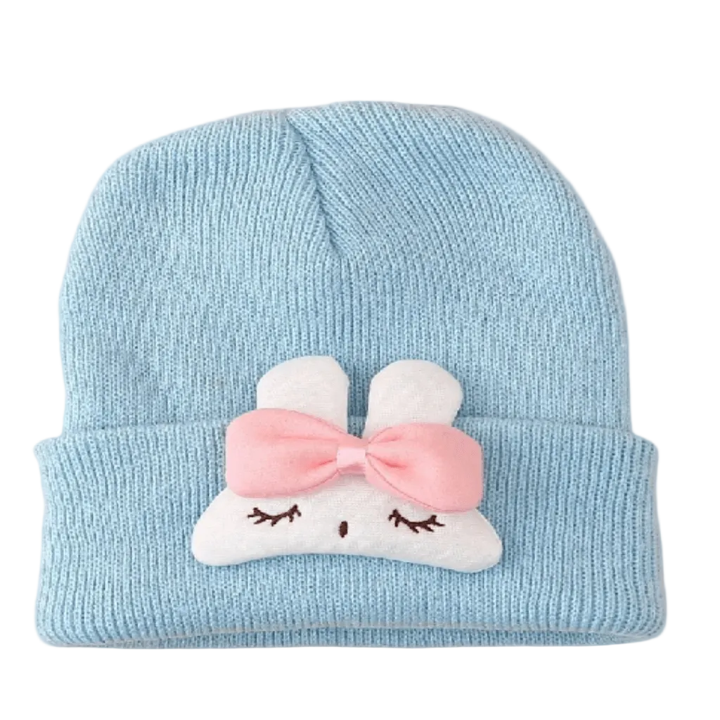 Light blue bunny knit beanie with pink bow.