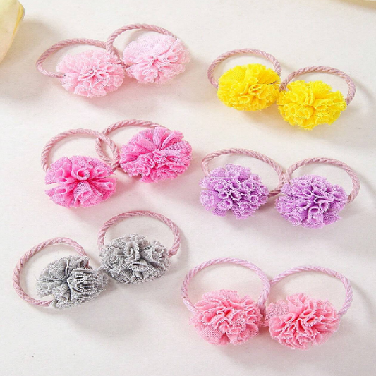 Set of colorful hair ties with floral designs on a white background