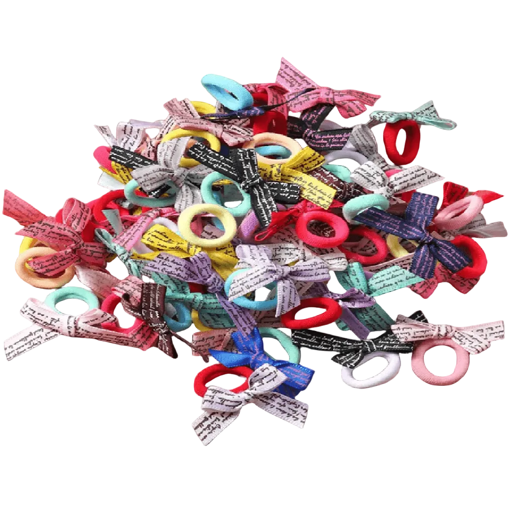 Assorted colorful hair bows with various designs on a light gray background