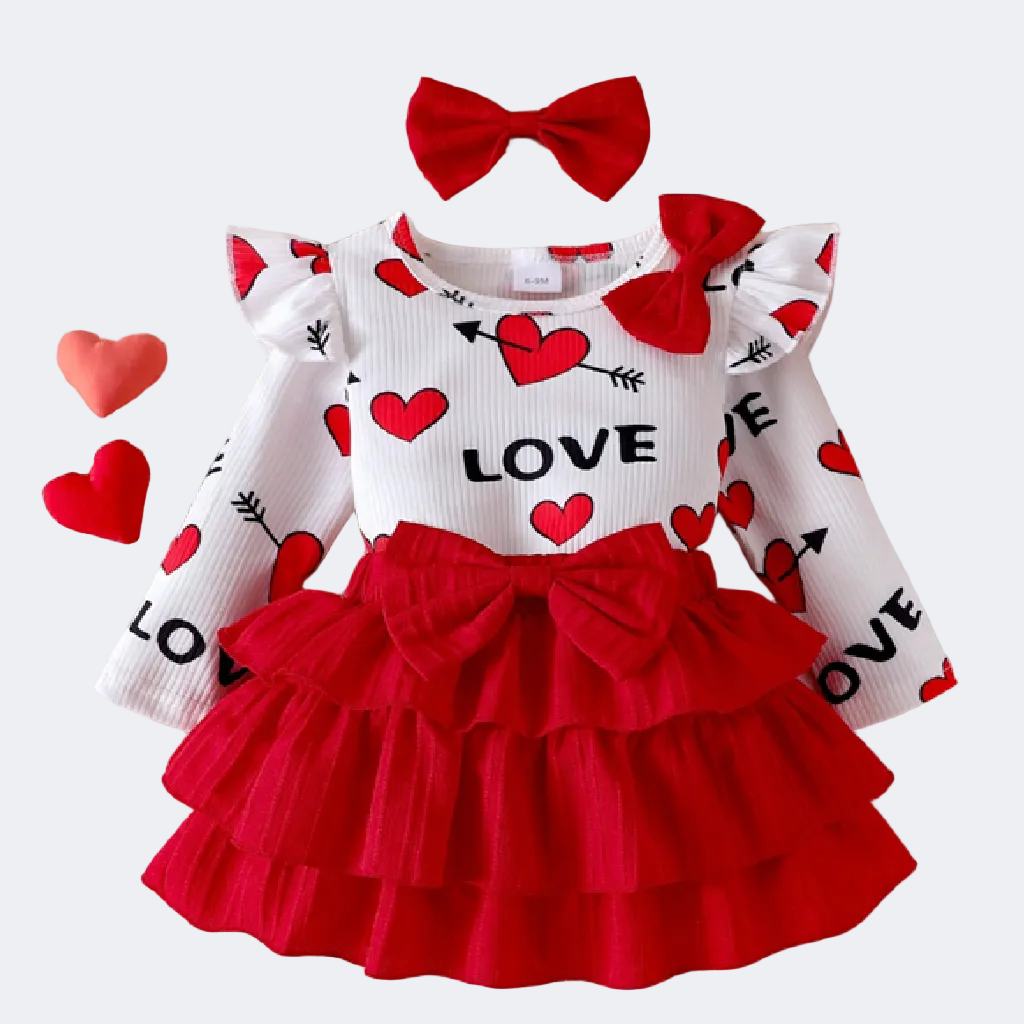 Children's outfit with red and white dress and matching headband on a textured surface.