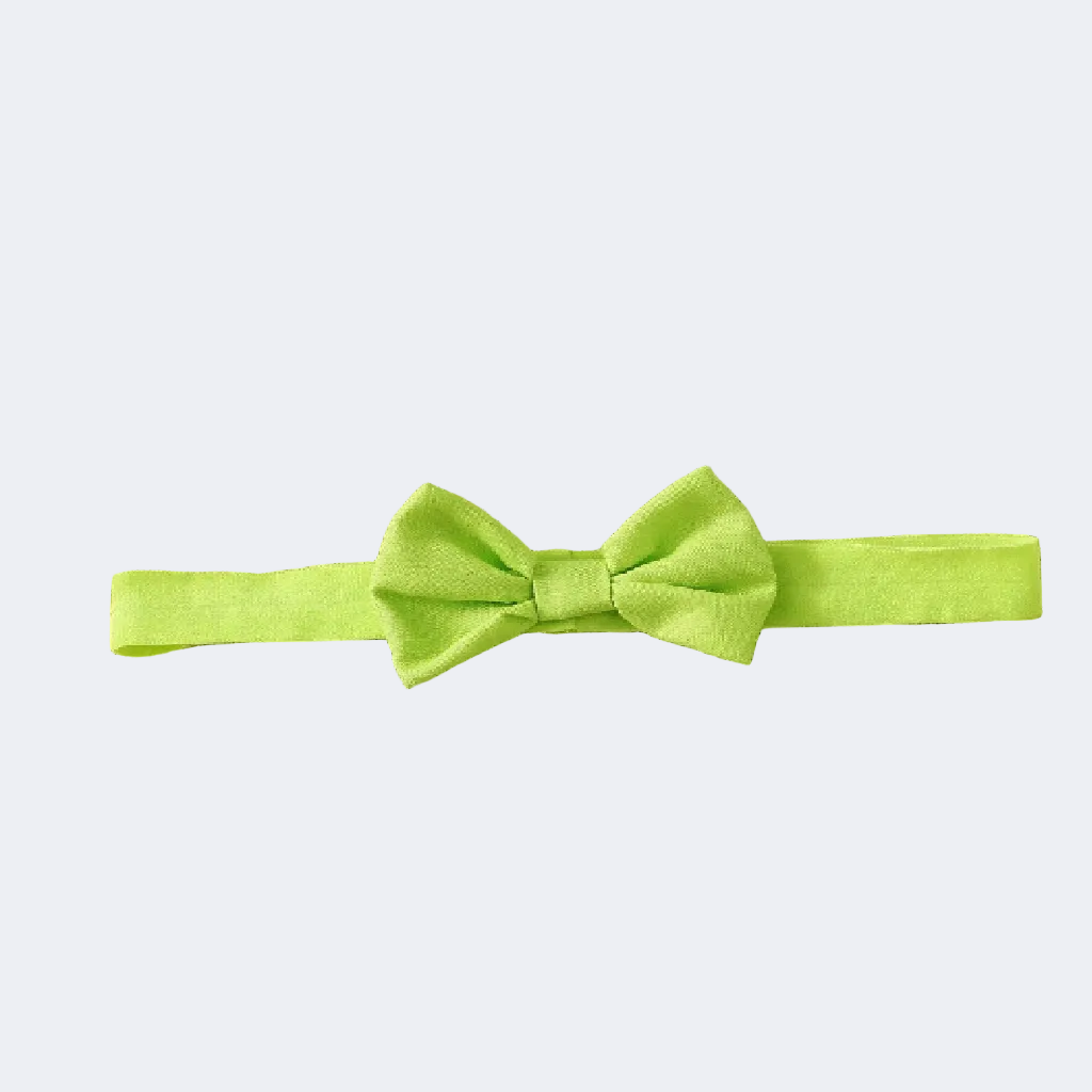 Green bow tie on a textured fabric background