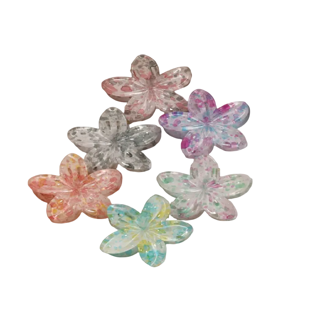 Colorful marble flower hair clips on a beige tray.