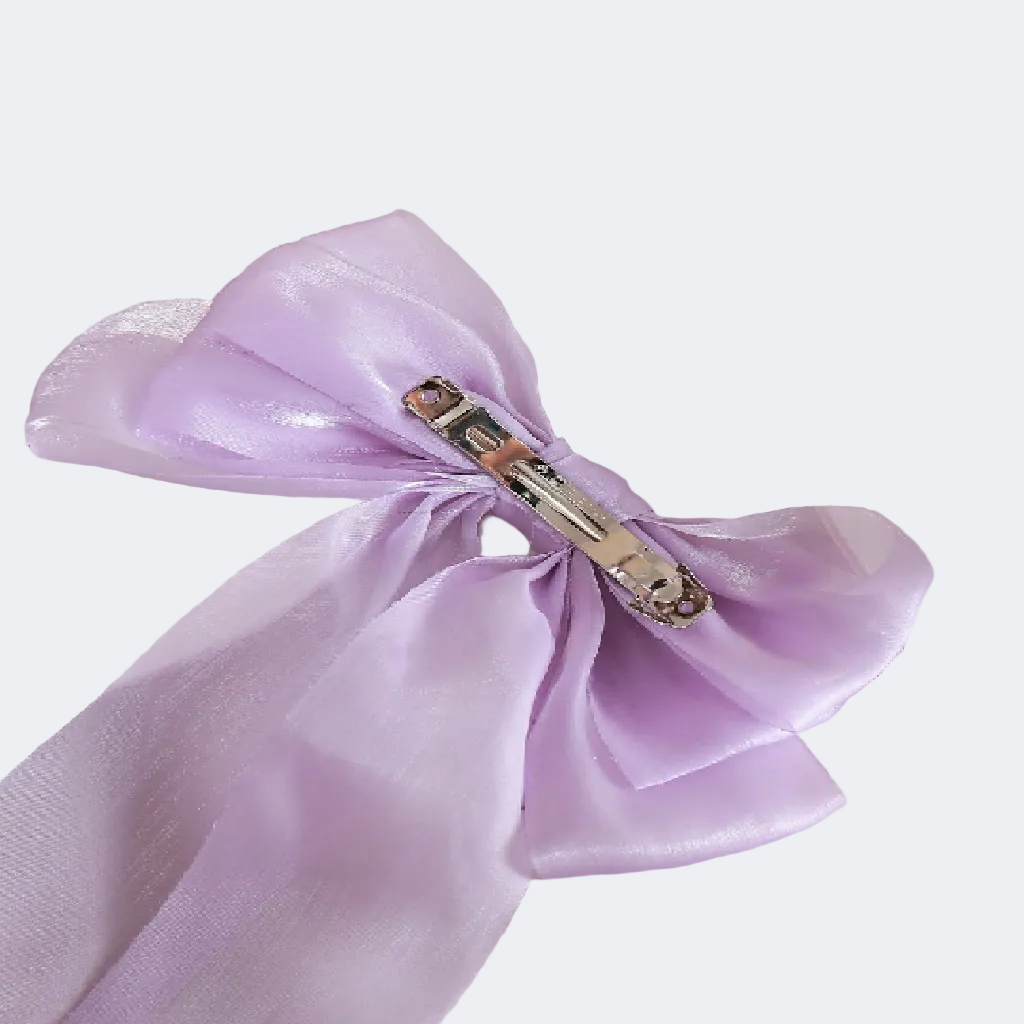 Purple napkin with a decorative clip on a white plate