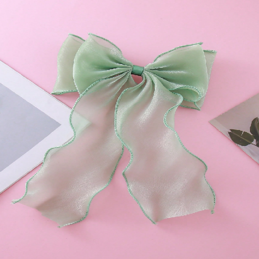 Green bow on a pink background