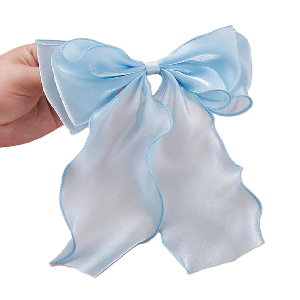 Large light blue bow held by a hand on a white background