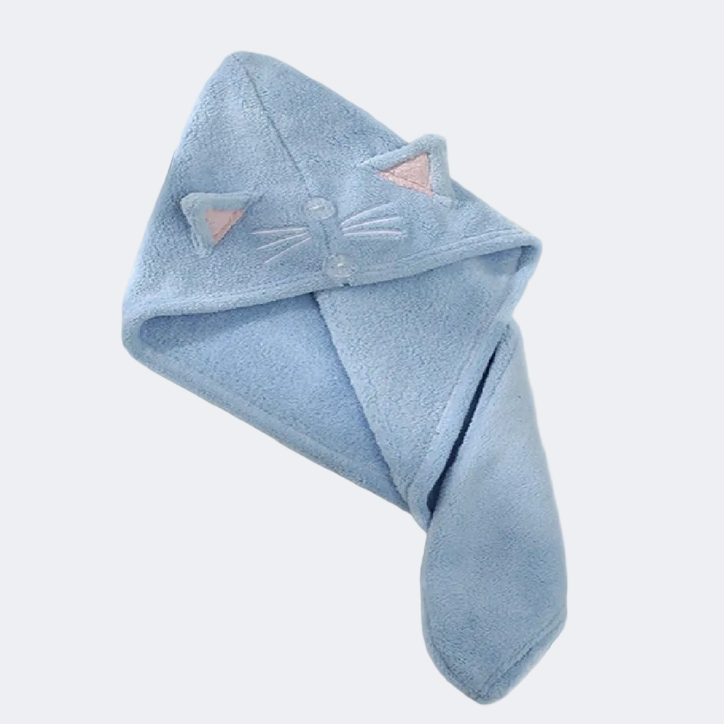 Blue hooded towel with cat ears and face on a white surface
