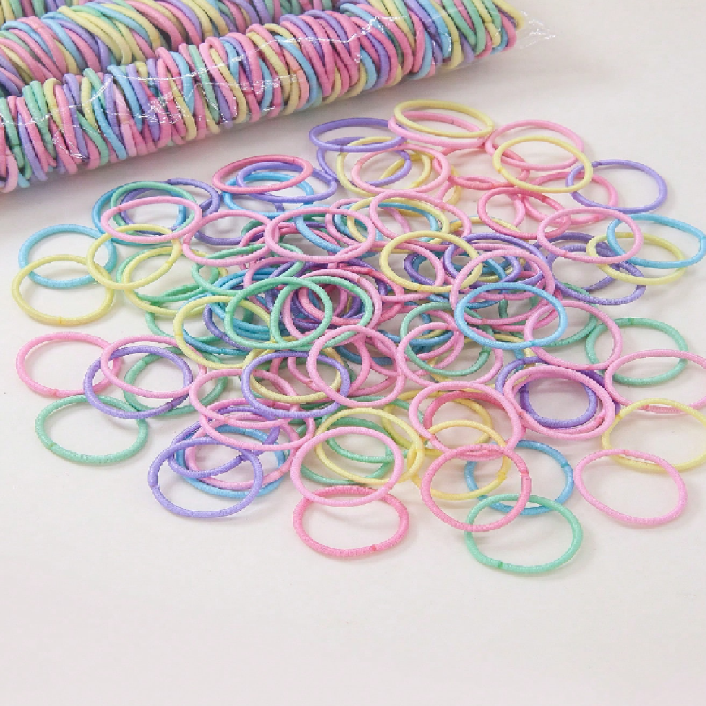 Pastel-colored rubber bands on a white background